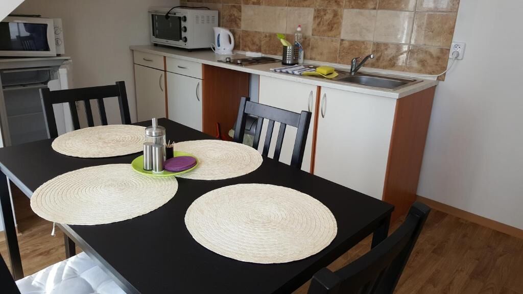 A compact kitchen with a dining area.