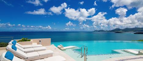 An infinity pool, pool loungers