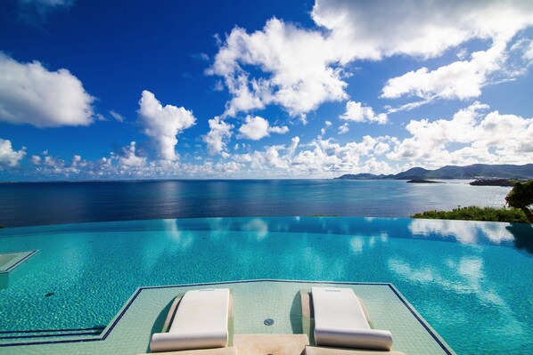 An infinity pool, sun loungers