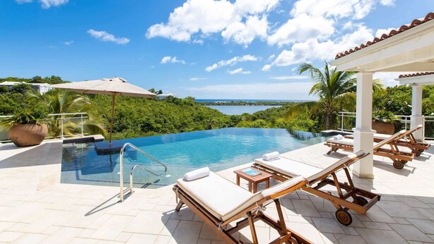 A pool area with lounge chairs, a pergola, and a view of a natural landscape. - Villa Sea Vous Play – Relaxed Oceanview Living in St. Martin (Cul-de-Sac)