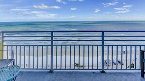 Ein Balkon mit Blick auf Strand und Meer.