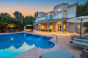 A two-story house with a swimming pool, outdoor seating, and a covered patio area. - Villa Verde Subach by Balearic Villas (Pollensa)