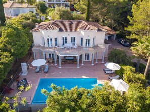 A large two-story house with a swimming pool, outdoor furniture, and a covered patio area. - Villa Verde Subach by Balearic Villas (Pollensa)