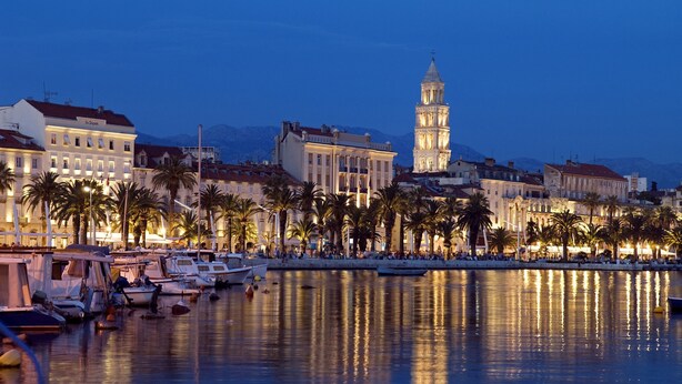 A marina with boats docked, a prominent tower, and buildings along the waterfront. - Modern & cozy apartment in amazing location just opposite to Dioclation's Palace (Split)