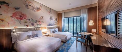 A hotel room with two beds, a desk, and a large window with blinds.