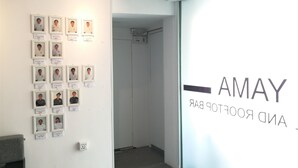 A hallway with framed photos on the wall and a sign that reads "AMAY AND FOOTBALL BAR". - Yama Hotel & Rooftop Bar (Yangon)