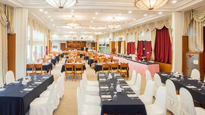 A banquet hall with multiple tables set for dining, white chairs, and chandeliers. - Ilsung Gyeongju Condominium Resort (Gyeongju)