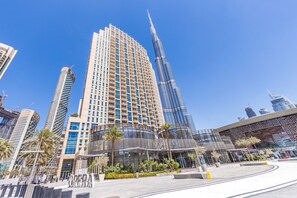 A modern building with a curved facade, large windows, and a prominent entrance. - Standpoint A by Deluxe Holiday Homes (Dubai)