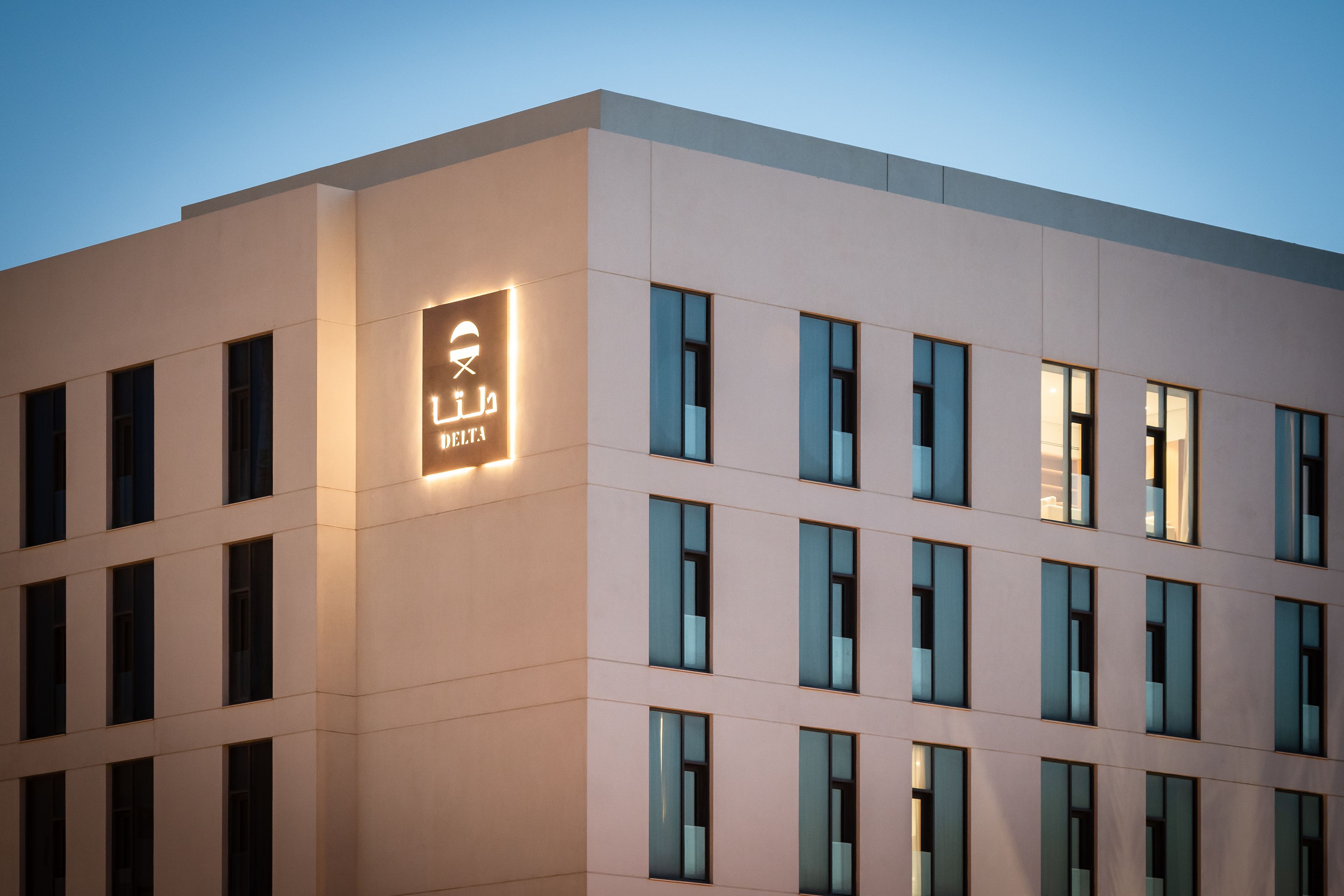 A modern building with a prominent sign reading "DELTA HOTEL" on the facade.