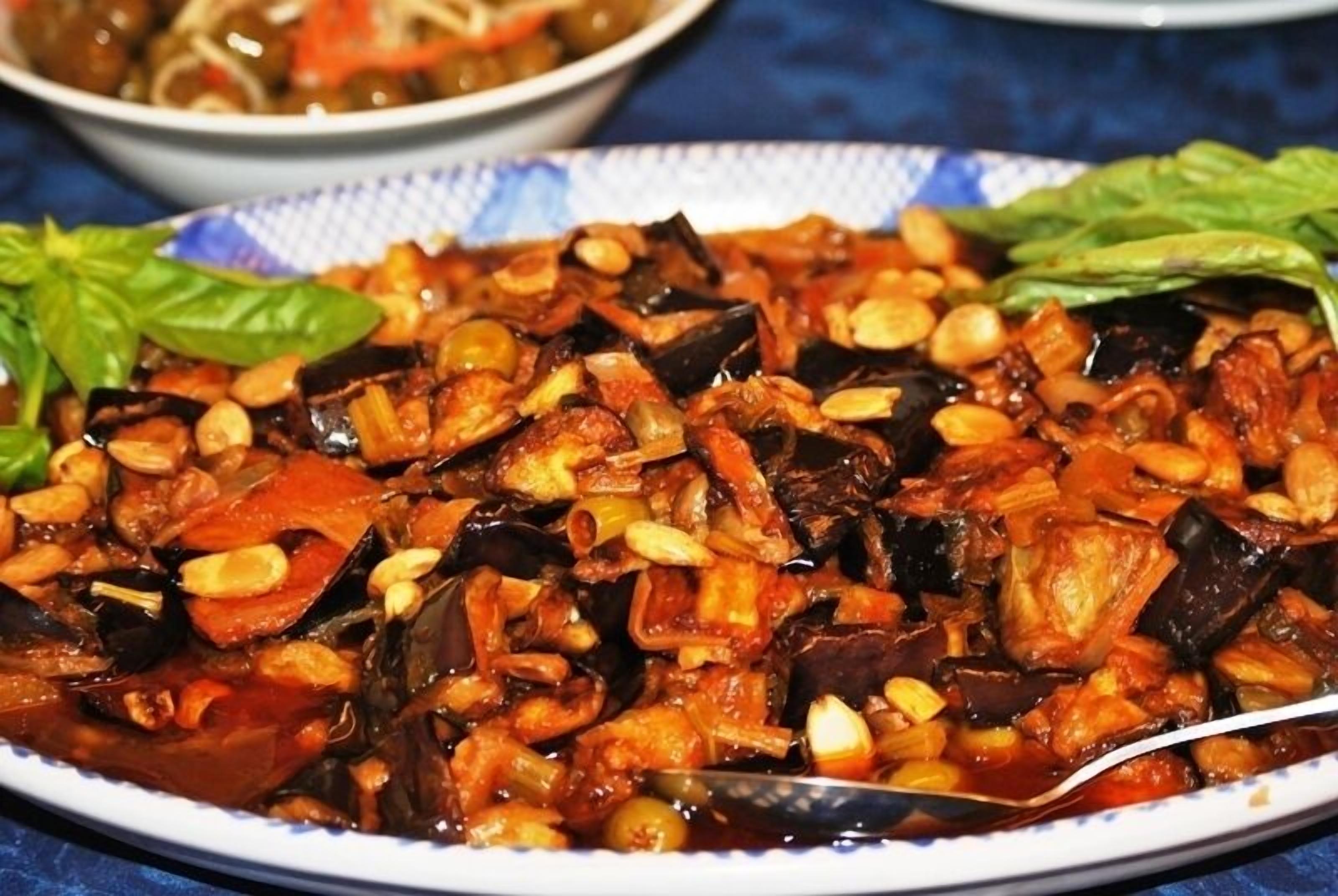 A dish of mixed vegetables and nuts on a plate.