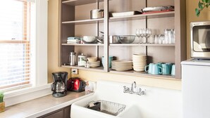 A kitchen with a built-in oven, a sink, and a window with blinds. - Charming & Historic Babs Condo on Hip Strip- Missoula's Best! (Missoula)