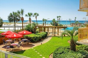 A resort pool area with umbrellas, lounge chairs, and a view of the beach. - On the Beach - First responders, Medical/Military discounts (destin)