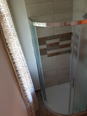 Shower, hair dryer, slippers, towels