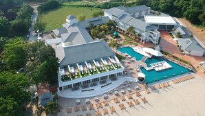 A resort with multiple buildings, a swimming pool, and a beach area. - Dash Resort Langkawi (Langkawi)