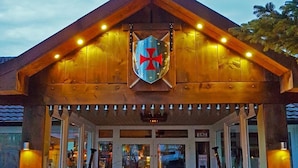 A wooden building with a shield emblem and a sign reading "BMZ". - Ostsee-Rittergut-Rügen – BinzHotel & OrdensKapelle (Binz)