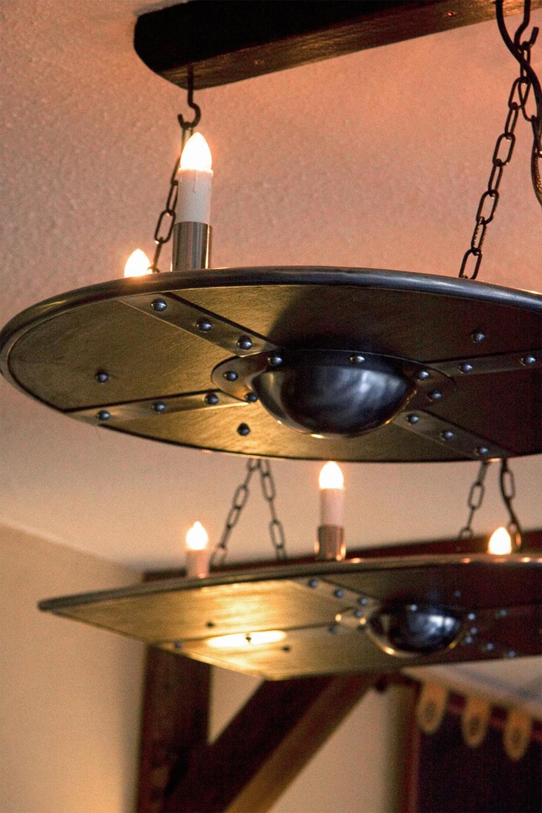 A multi-tiered, metal-framed chandelier with candles.