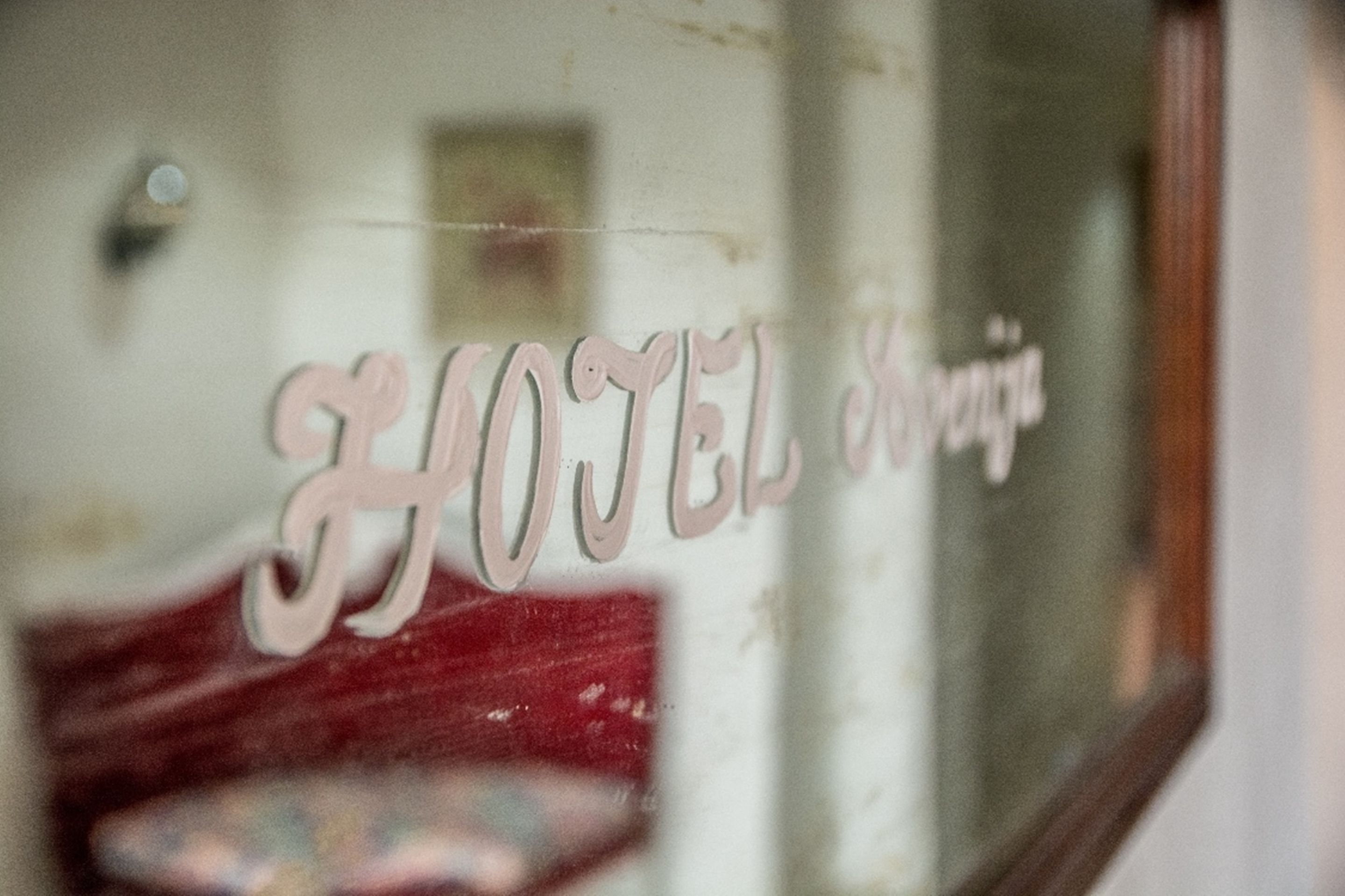 A window with the words "HOTEL" etched into it.