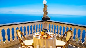 Un balcon avec une table préparée pour le petit-déjeuner, offrant une vue panoramique.