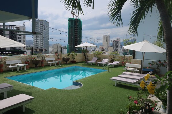 Outdoor pool, open 8 AM to 10 PM, pool umbrellas, pool loungers