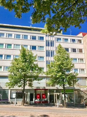 A multi-story building with a ground-floor shop named "PRO FORMA".