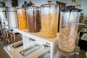 A self-serve food station with multiple dispensers for different types of grains and cereals. - Mera Onix Cap Aurora (Cap Aurora)