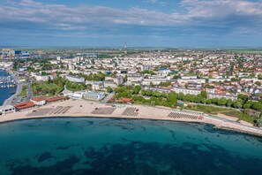 An aerial view of a coastal city with a marina, buildings, and a beach area. - Mera Brise (Mangalia)