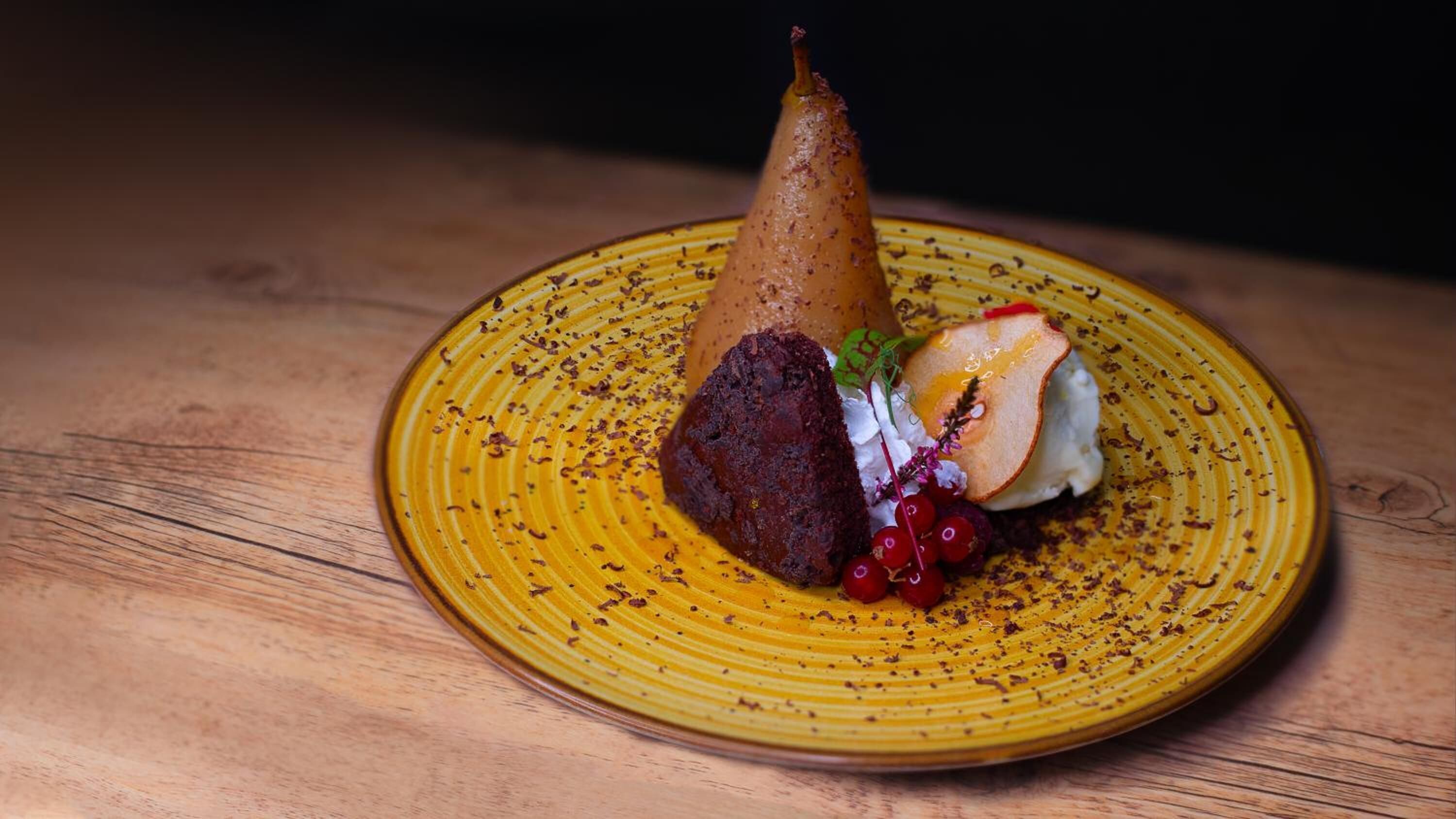 A dessert on a yellow plate with a wooden table background.