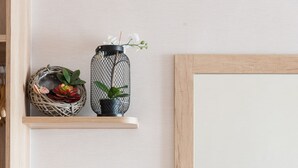 A minimalist kitchenette with a kettle, tea set, and decorative items on shelves. - Kenting Kaiying Hotel (Hengchun)