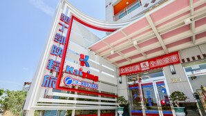 A modern building with a prominent sign for 'Kaiying' and a contact number. - Kenting Kaiying Hotel (Hengchun)
