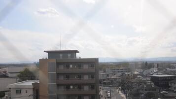 A multi-story building with a flat roof and a small antenna on top.