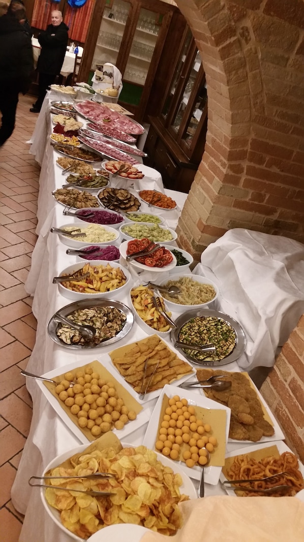 A buffet table with various food items.