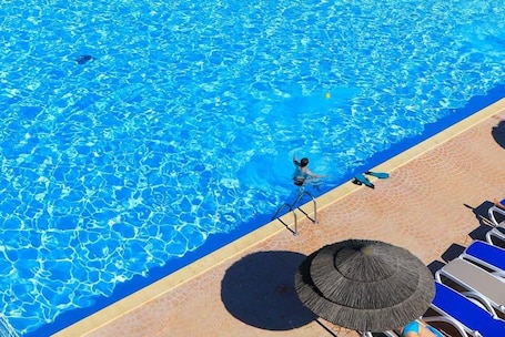 Indoor pool, outdoor pool, open 9:30 AM to 6:30 PM, pool umbrellas