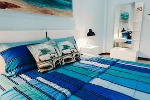 A bedroom with a bed, a nightstand, a lamp, and a wall with a painting. - Peach Hua Hin Pool Villa Holiday (Hua Hin)