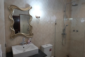 A bathroom with a sink, mirror, toilet, and shower. - Peach Hua Hin Pool Villa Holiday (Hua Hin)