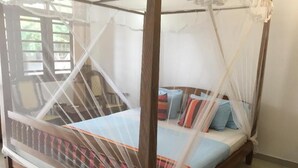 A four-poster bed with a canopy, a striped bedspread, and multiple pillows. - Samaru Beach House (Weligama)