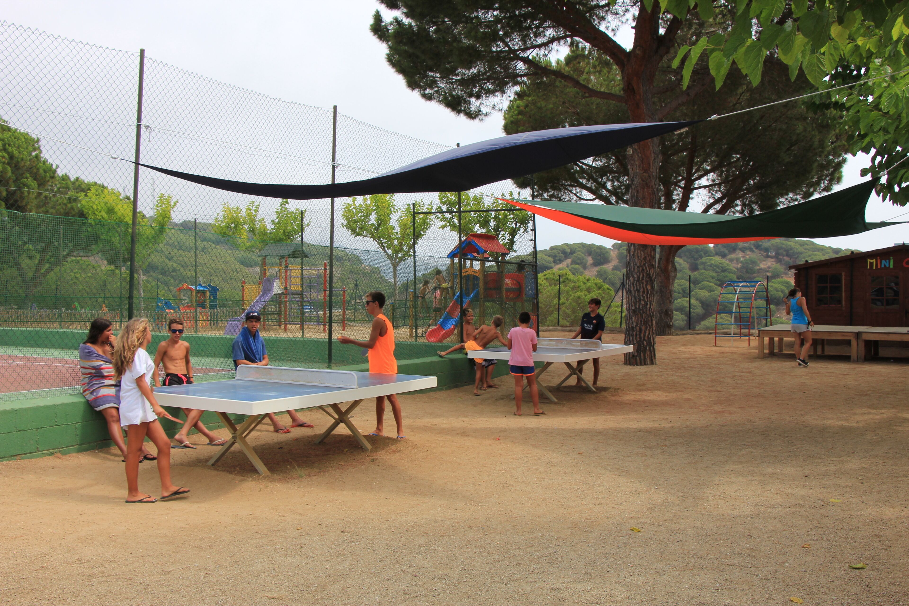 A playground with tables and a slide.