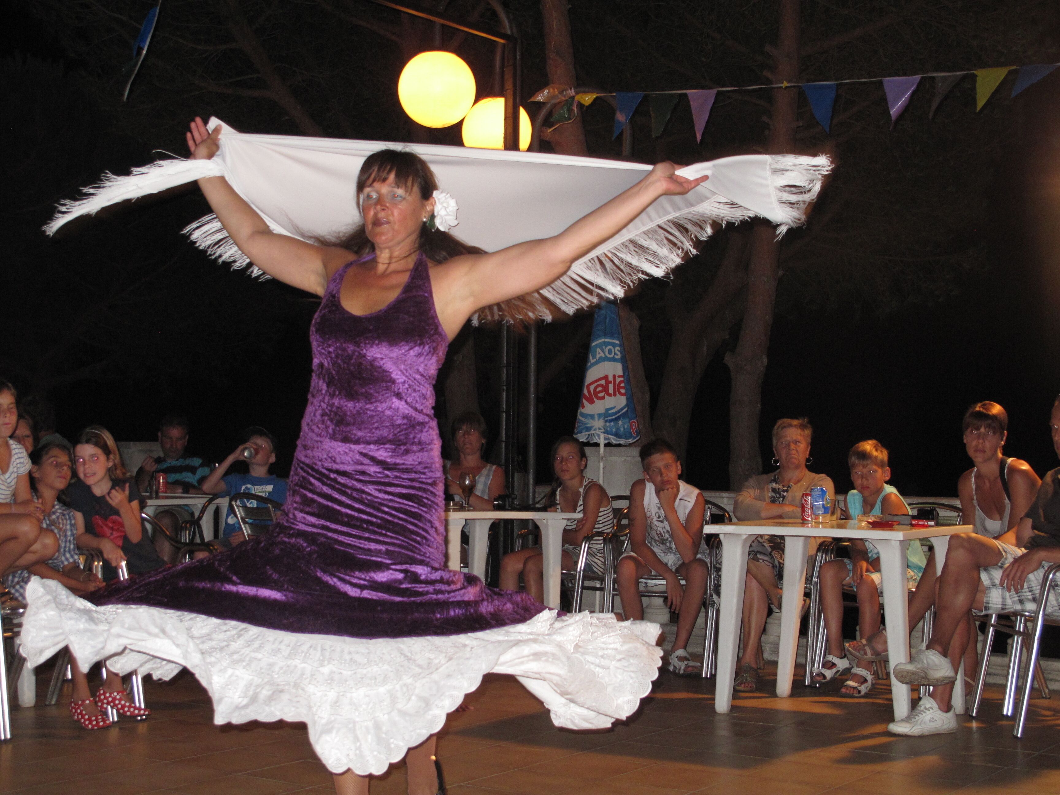 A person in a purple dress performing a dance.