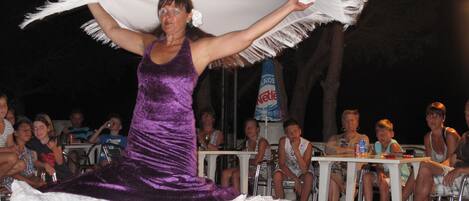 A person in a purple dress performing a dance.