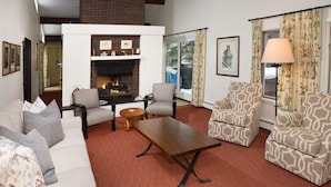 A living room with a fireplace, patterned armchairs, a sofa, and a table. - 385 Forest Rd. 4 Bedroom Home by RedAwning (Vail)