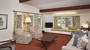 A living room with patterned armchairs, a sofa, a coffee table, and a TV. - 385 Forest Rd. 4 Bedroom Home by RedAwning (Vail)