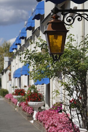Une rangée de bâtiments avec des auvents bleus et un lampadaire.