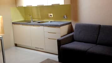 Deluxe Apartment, 1 Bedroom, Kitchenette | Living area | Flat-screen TV