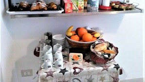 A buffet setup with various food items and beverages. - Caudullo (Letojanni)