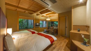 A hotel room with two beds, a desk, and a TV. - Tousin-an Komeya (Ito)