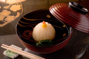 A bowl of food with chopsticks and a small dish beside it. - Tousin-an Komeya (Ito)