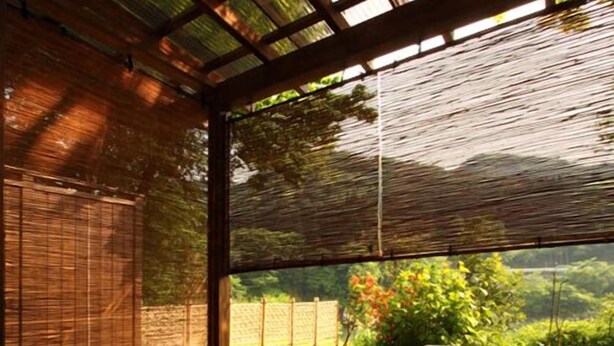 A traditional Japanese room with tatami flooring, a wooden bench, a small hot spring bath, and a view of greenery outside. - Shikinosato Kikuya (Sekikawa)