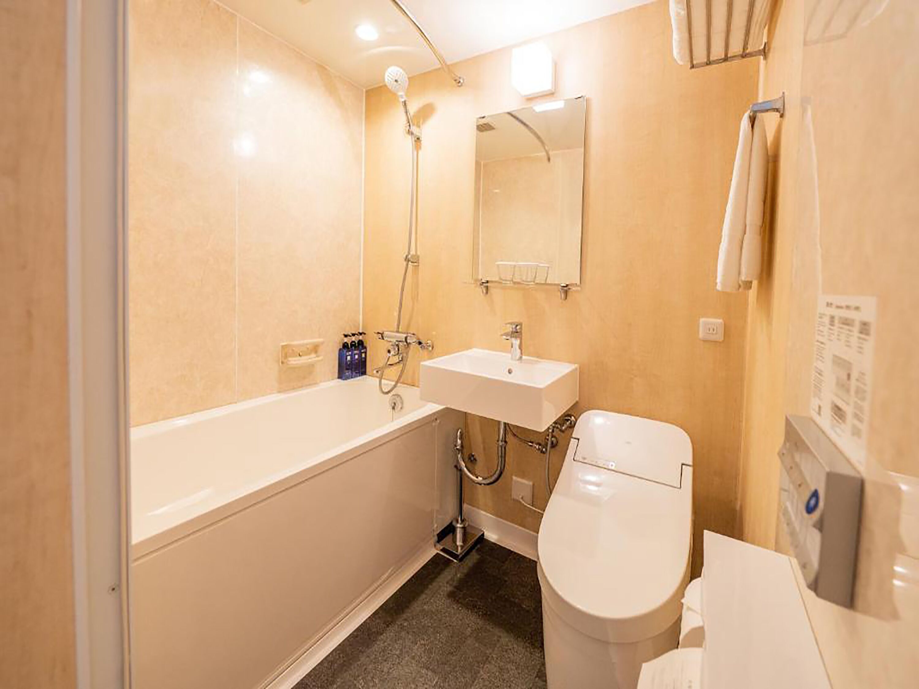 A bathroom with a bathtub, sink, and toilet.