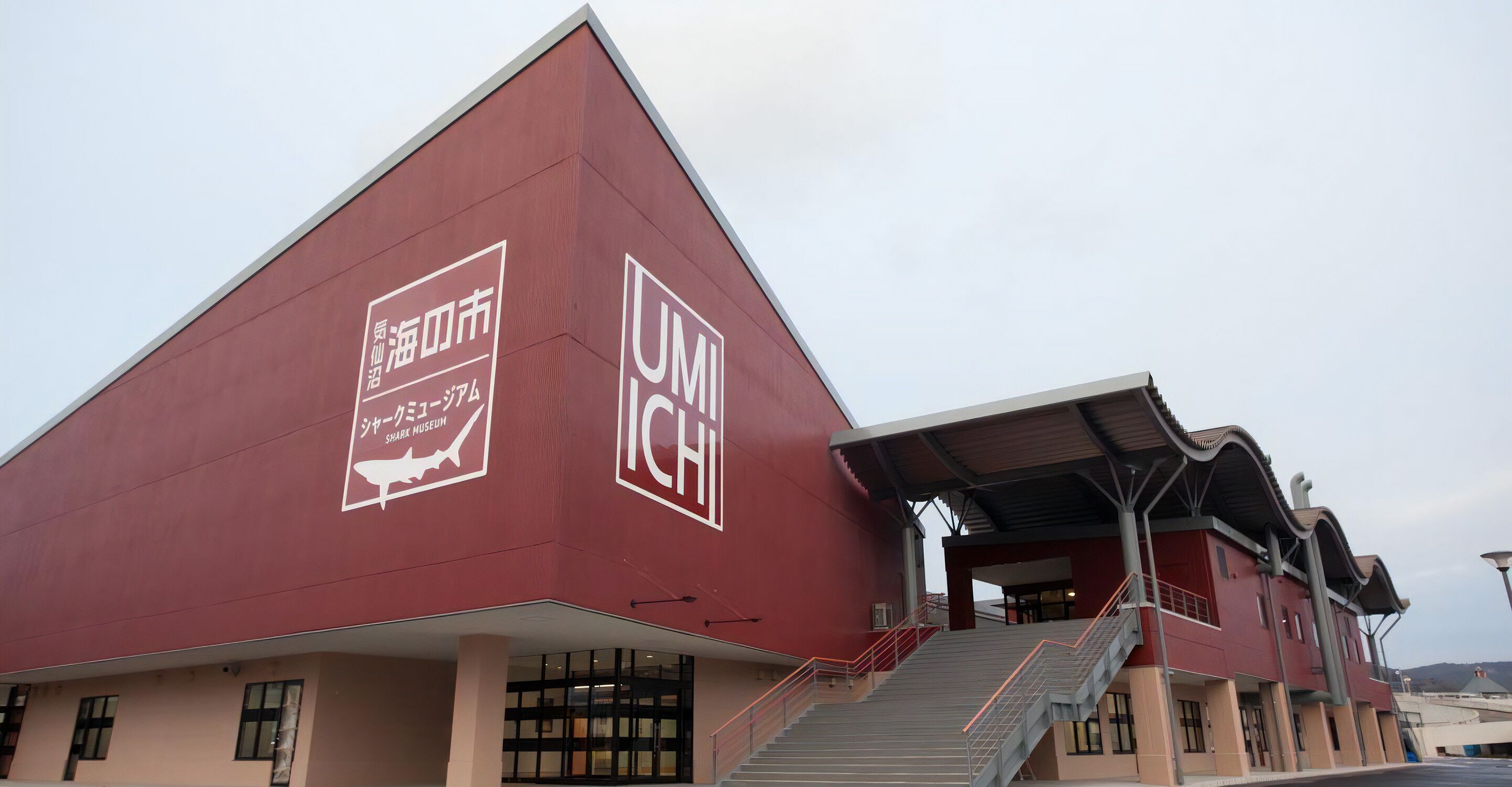 A modern building with a prominent UMI logo and signage for the Shark Museum.