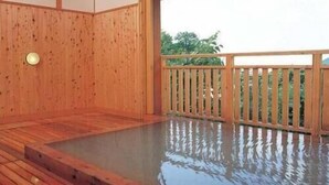 A wooden deck with a hot tub, wooden walls, and a railing. - Matsukaneya Annex (Yamagata)