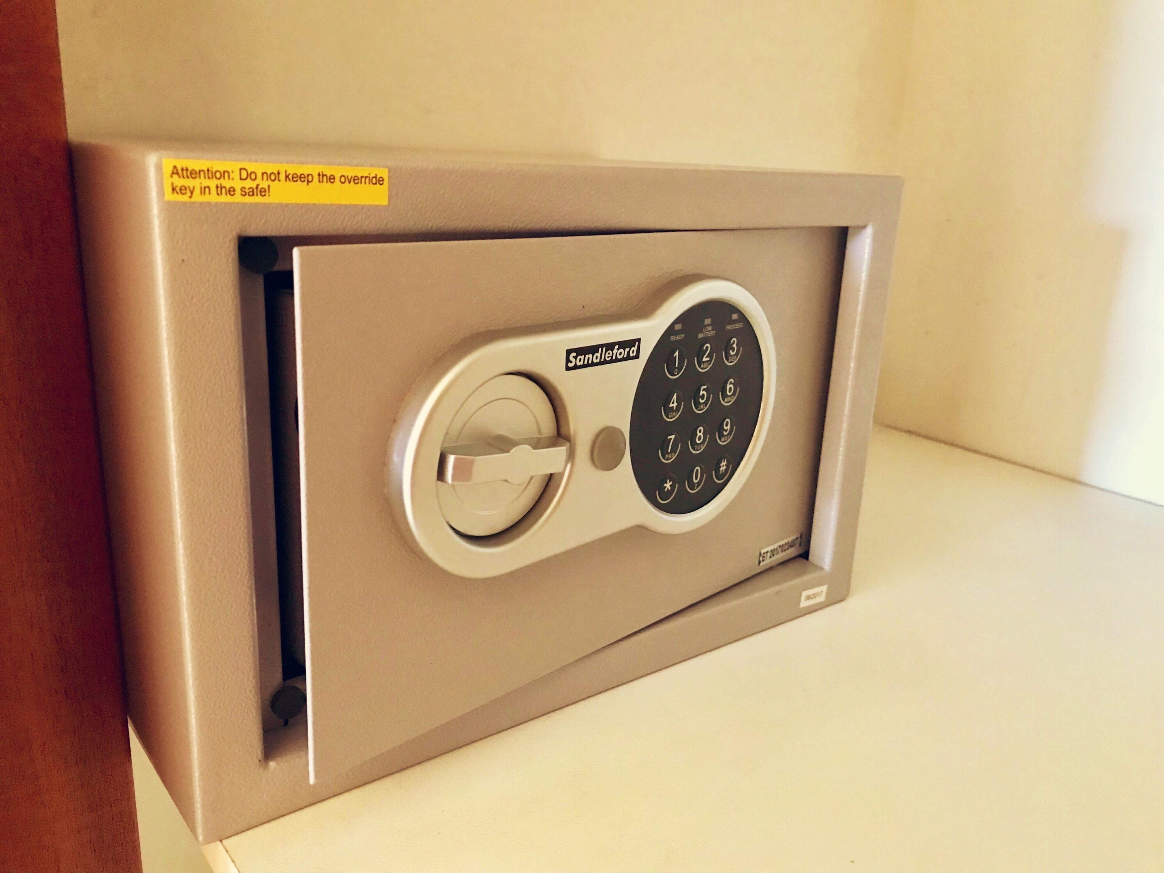 A safe with a combination dial and a keypad, labeled 'Sandleford'.
